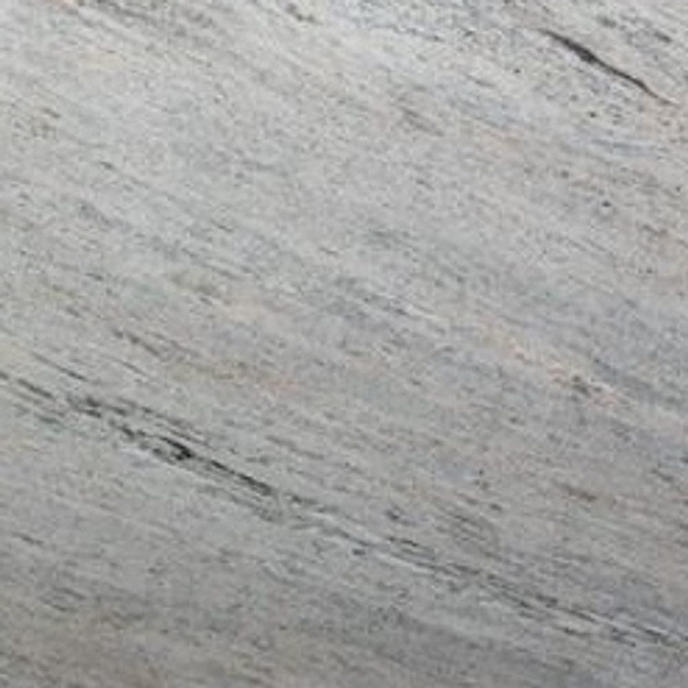 Ivory Fantasy granite, a pale cream stone with soft grey movement, photographed as a full slab