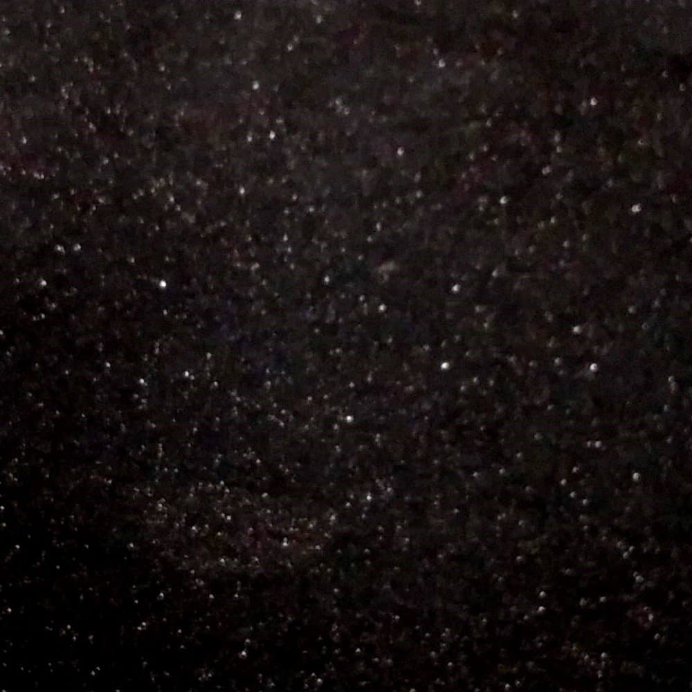 Star Galaxy granite swatch: a black ground scattered with fine bronze flecks