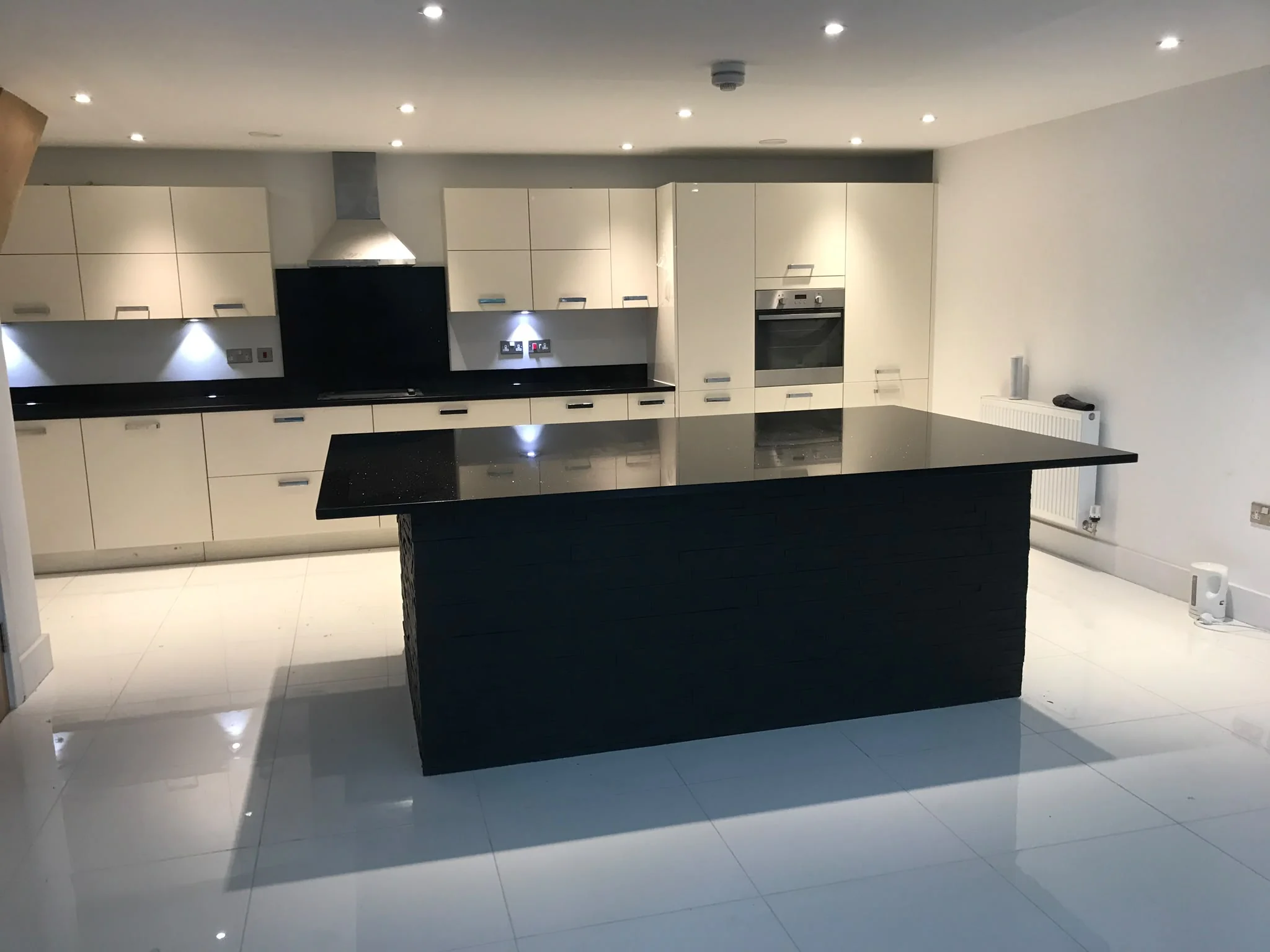 Star Galaxy Granite island and worktops with cream kitchen cabinets.